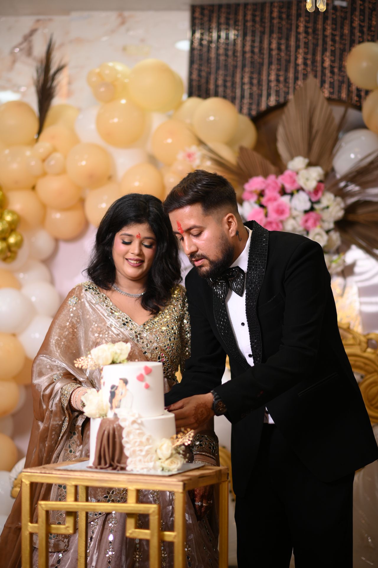 The couple cut their engagement cake together
