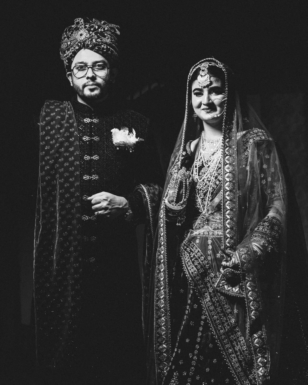 Black and white portrait of a bride and groom standing together