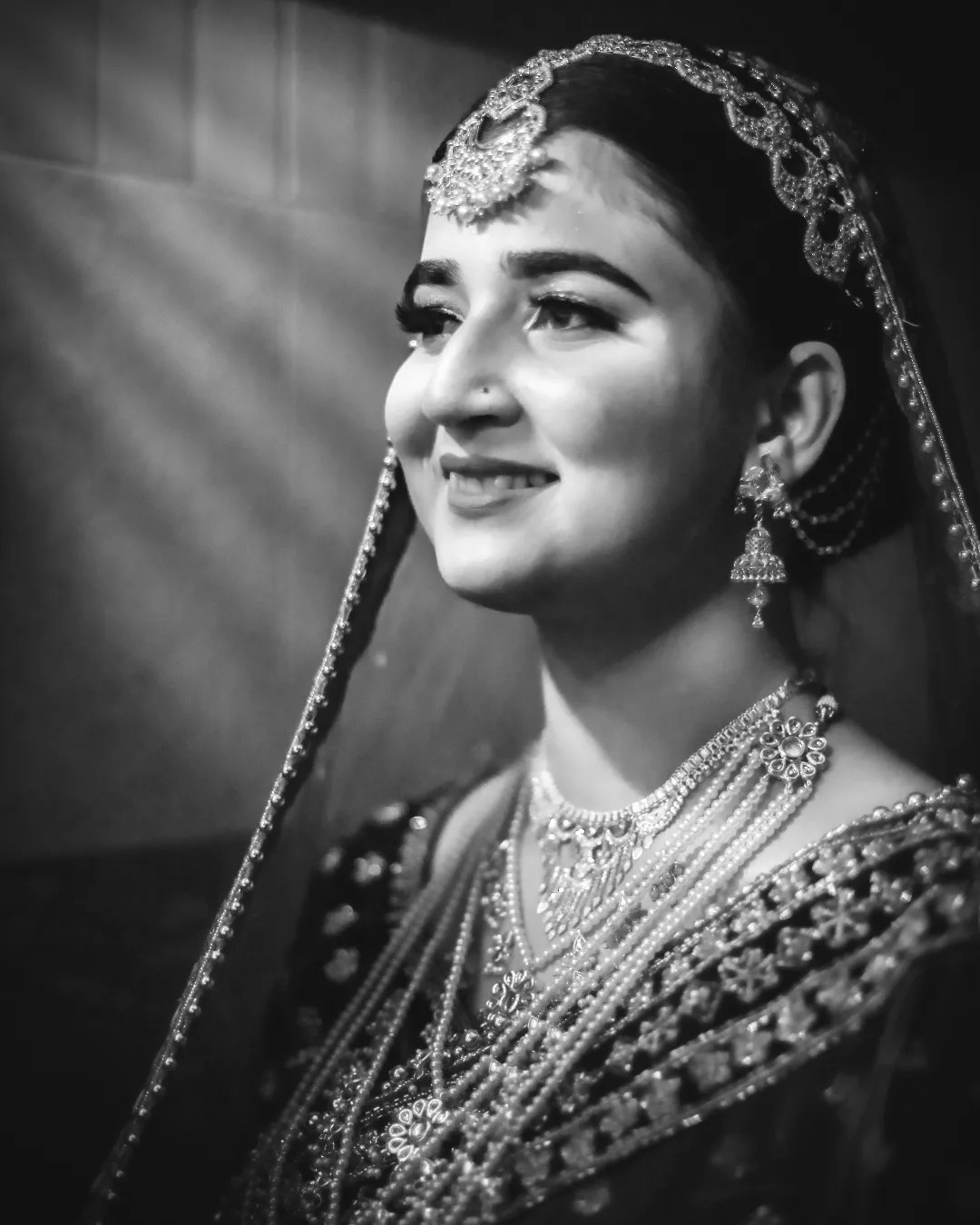Black and white portrait of a smiling bride