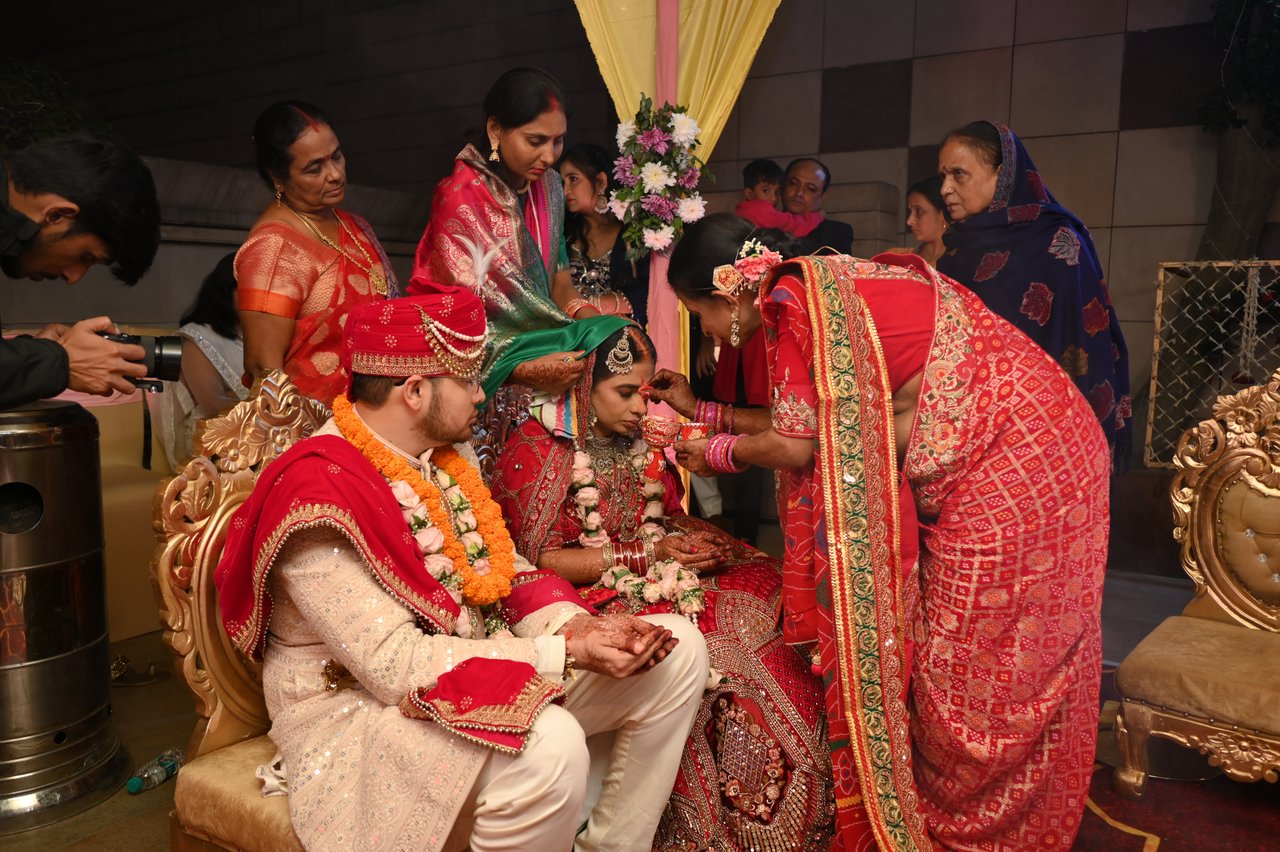 Family members gather around the couple during the wedding rituals