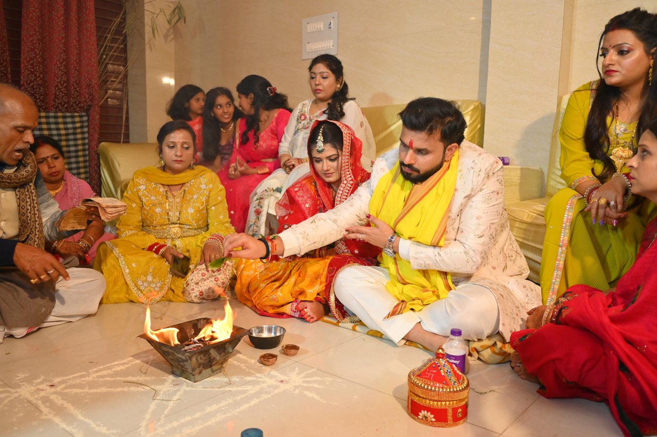 The couple perform a ritual on the floor surrounded by family